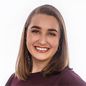 Professional headshot of Grace Schuler, she is smiling against a white background